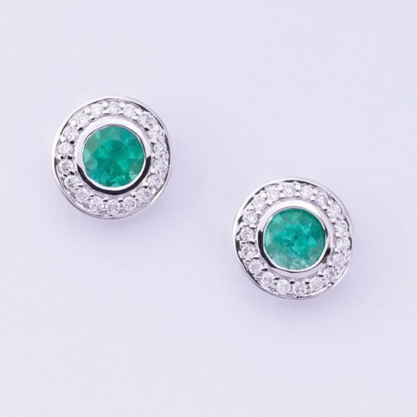 18 carat white gold emerald and diamond stud earrings.