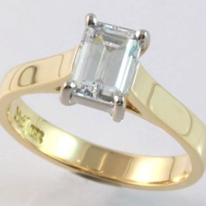 18 carat yellow and white gold solitaire emerald cut diamond ring.