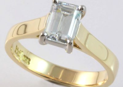 18 carat yellow and white gold solitaire emerald cut diamond ring.