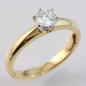 18 carat yellow and white gold brilliant cut diamond solitaire ring with hinge fitting.
