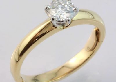 18 carat yellow and white gold brilliant cut diamond solitaire ring with hinge fitting.